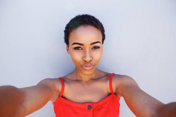 istock cool young african american woman taking selfie 857552144