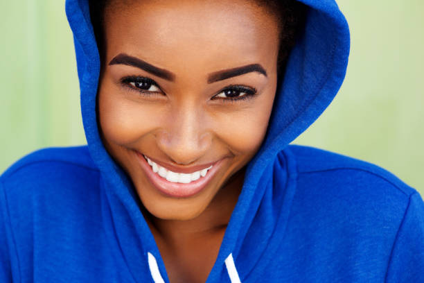istock smiling young black woman with blue sweatshirt 857552446