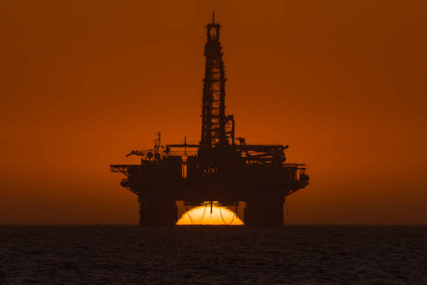 istock Sun setting behind oil drilling platform at Longbeach in Namibia 857555630