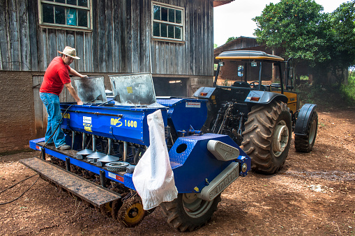 Parana, Brazil, December 08, 2009: Farmers do cleaning and maintaining a planter machine on a farm in Parana