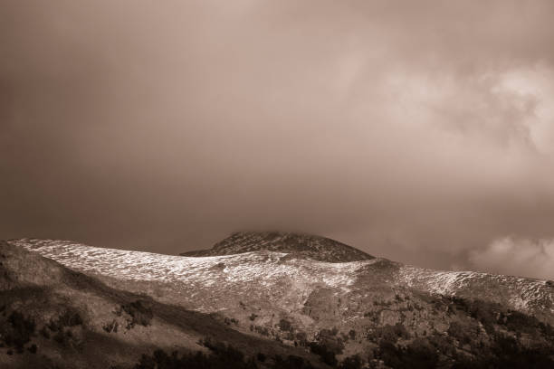 istock Yosemite mountains consumed by clouds, in sepia 857573010