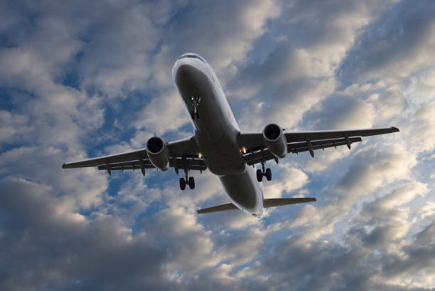 istock Airplane flying in sky with beautiful clouds 857581170