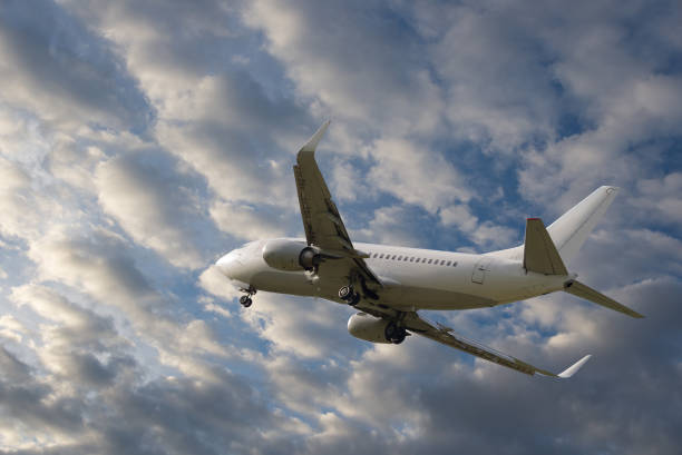 istock Airplane flying in sky with beautiful clouds 857581694