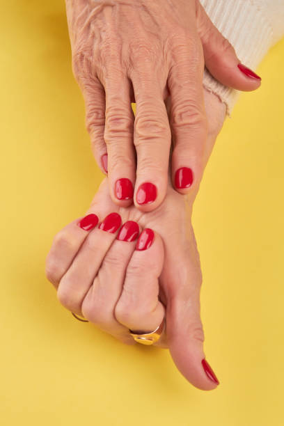 istock Old woman hands with red manicure. 857582562