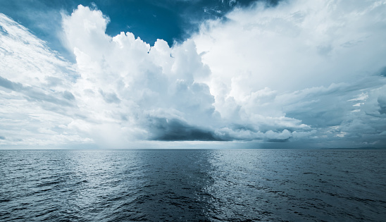 Dark clouds in open ocean. Tropical hurricane and sea storm