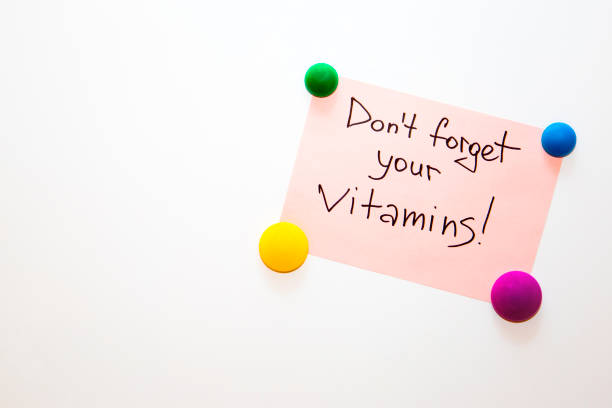 istock Fridge note with the text about wellness: Don't forget your vitamins! 857585324