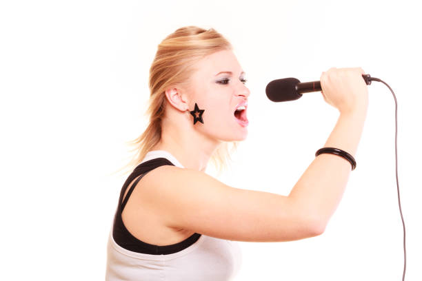 istock Blonde woman singing to microphone, profile view 857585700