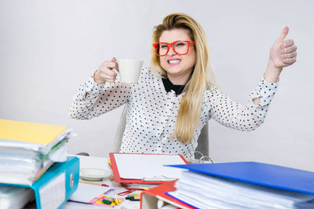 istock Happy woman at office drinking hot coffee 857585948