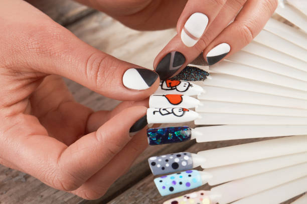 istock Close up of female hands and nail art samples. 857586194