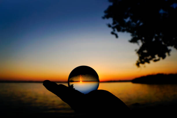 istock Magic crystal ball reflection at sunset on the lake 857586350