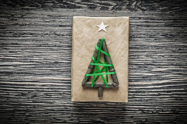 istock Christmas handmade wrapped present box on wooden board 857592700