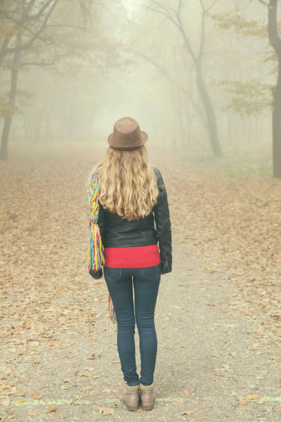 istock Young woman in autumn park 857593046