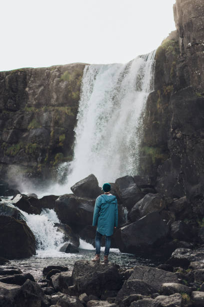 istock Man walking near   waterfall in mountains 857595730