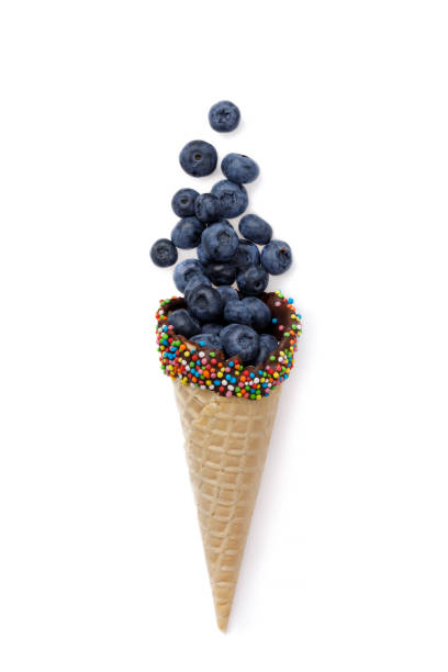 istock Ripe blueberries in a waffle horn isolated on white background. View from above 857599050