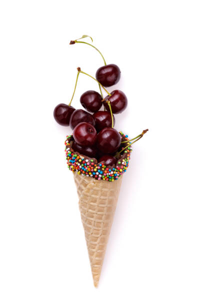 istock Ripe cherry in a waffle horn isolated on white background. View from above 857599064