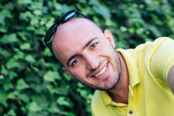 istock Young bald man taking selfie and smiling 857599068