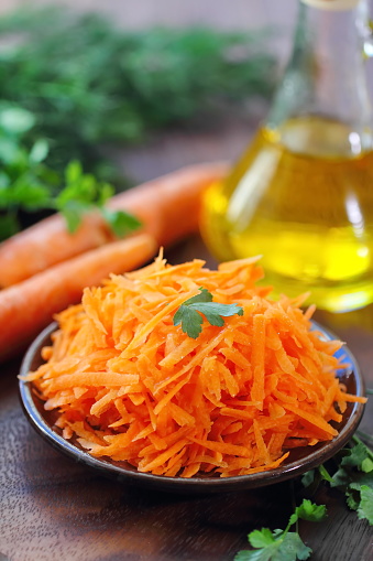 Salad with grated carrot and greens on a plate