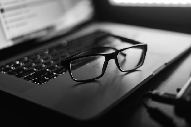 istock Glasses and a laptop on the table 857599944