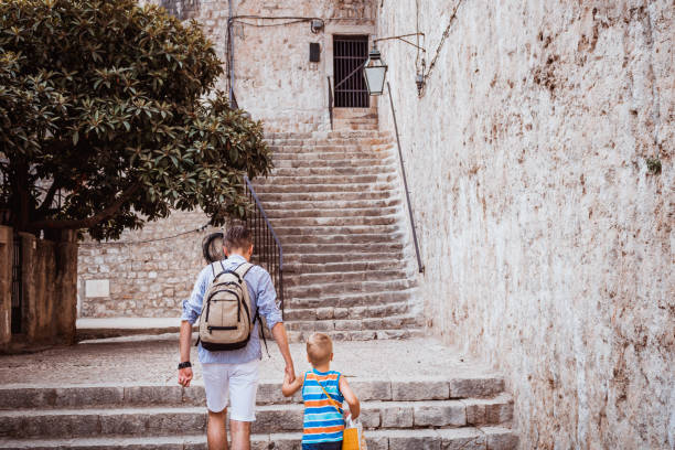 istock Father and son holding hands and walking. 857602838