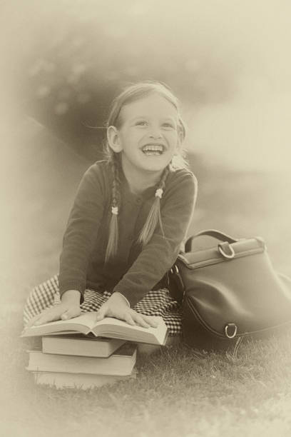 istock Preschooler girl ready back to school, reading textbooks. 857602892