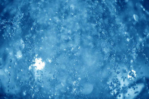 istock blue spray fountain at night 857605976