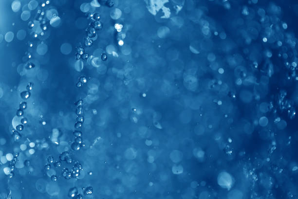 istock blue spray fountain at night 857606078