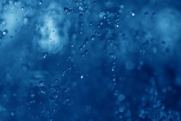 istock blue spray fountain at night 857606118