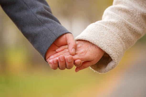 istock Elderly couple holding hands 857609502