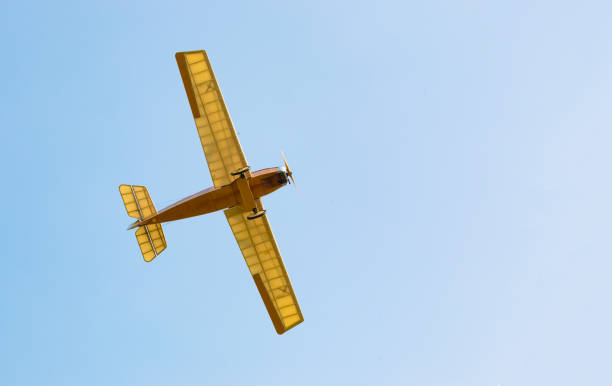 istock Vintage yellow airplane in blue sky 857612694