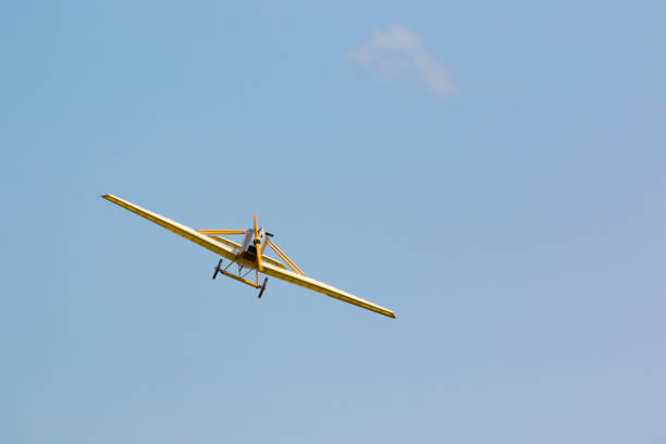 istock Vintage yellow airplane in blue sky, sky background 857612704