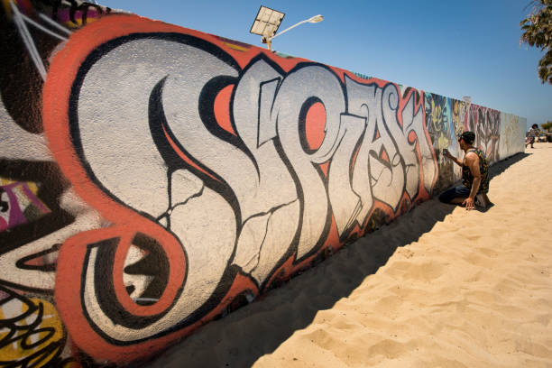 Venice Beach: Graffiti are writing or drawings that have been scribbled, scratched, or painted illicitly on a wall or other surface, often within public view.  Graffiti range from simple written words to elaborate wall paintings.  Venice is a residential, commercial, and recreational beachfront neighborhood within Los Angeles, California. It is located within the urban region of western Los Angeles County known as the Westside.