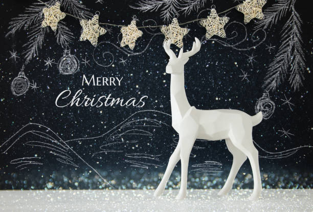 istock White reindeer on wooden table over chalkboard background whith hand drawn chalk illustrations. 857620696