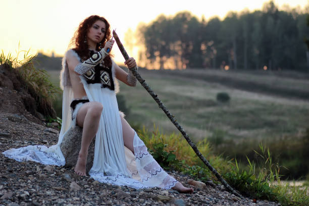 istock girl with spear at the river 857620830