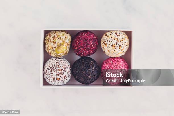 Box Of Energy Raw Bites On White Marbe Table From Above Stock Photo - Download Image Now