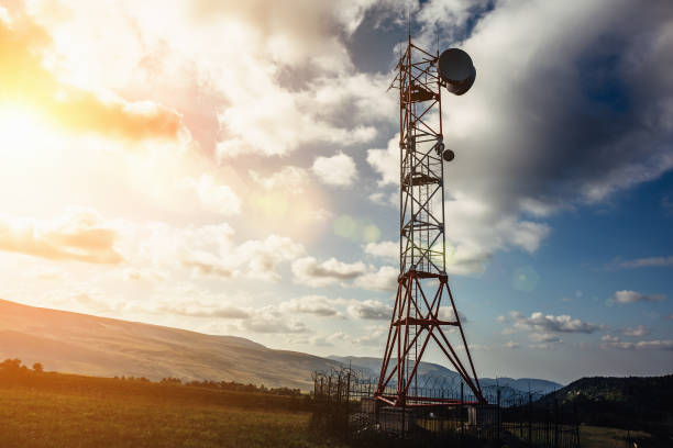 istock Telecommunication tower with dish and mobile antenna on mountains at sunset sky background 857623940