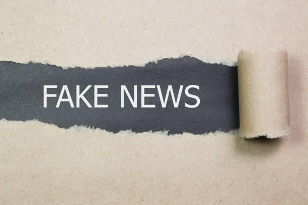 istock FAKE NEWS word written under torn paper. 857624242