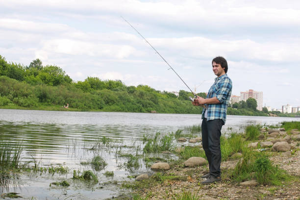 istock A man with a beard is fishing in the river 857627502