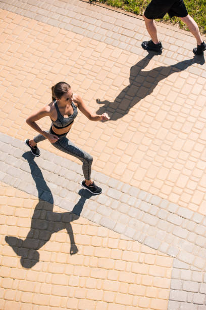 istock woman jogging on street 857630272