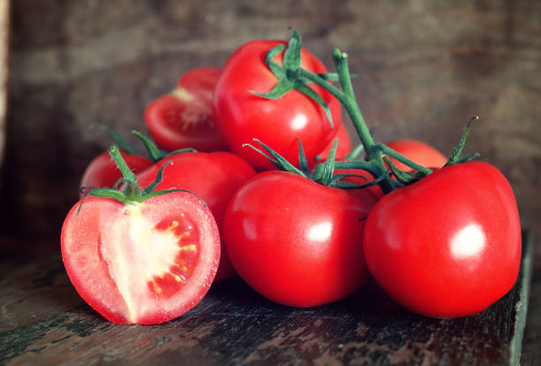 istock tomatoes on wooden background 857631146