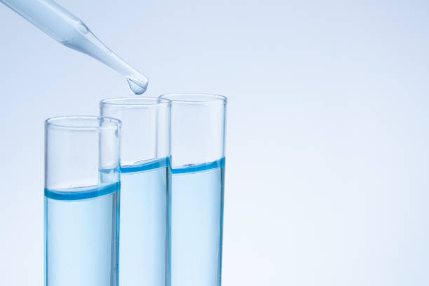 istock Science pipette with a pour of substance over laboratory test tubes 857641858