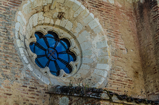 Detail of chapel window in the port of the medieval village of Auvillar, near the river Garonne, France.