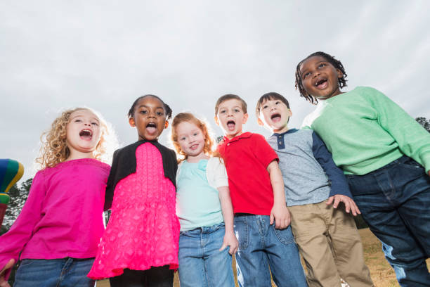 istock Multi-ethnic group of young children standing in a row 857645194
