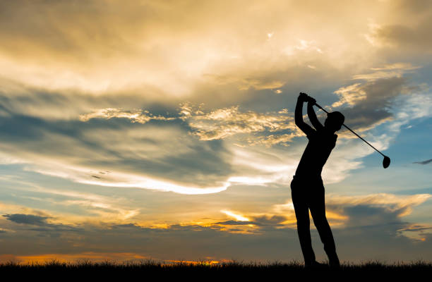 istock silhouette golfer playing golf during beautiful sunset 857645224