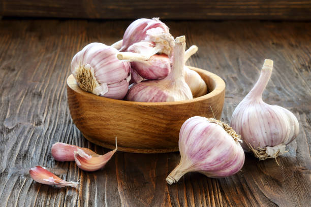 istock Garlic in a wooden bowl 857645362