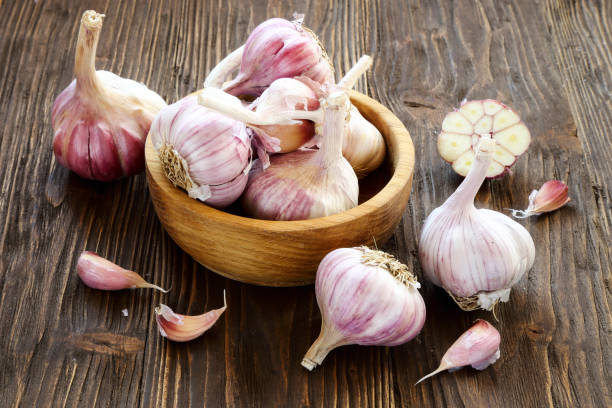 istock Garlic in a wooden bowl 857645546