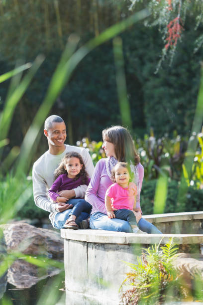 istock Interracial family sitting in a park 857645812