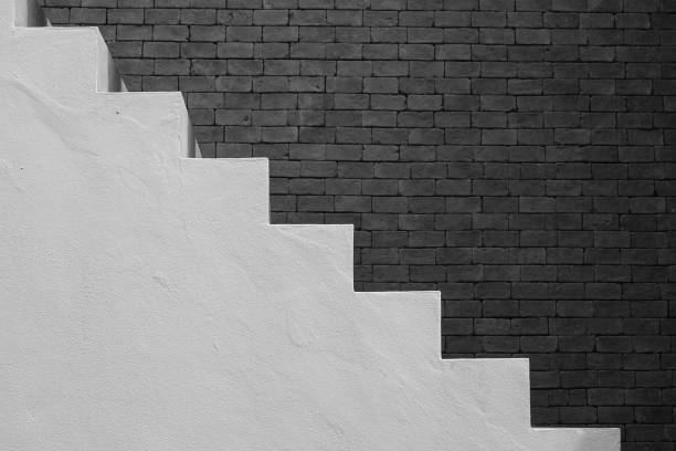 istock Side view of white empty stairs with brown brick wall background in vintage style. (Black and White filter effect) 857652044