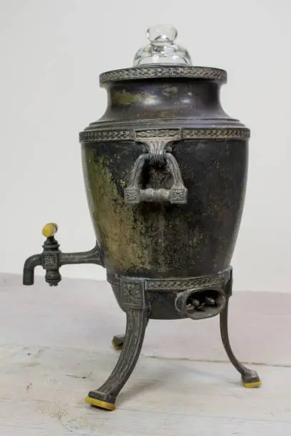An old, tarnished, silverplate coffee pot