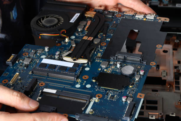 istock The laptop's motherboard is in the hands of the master 857656542
