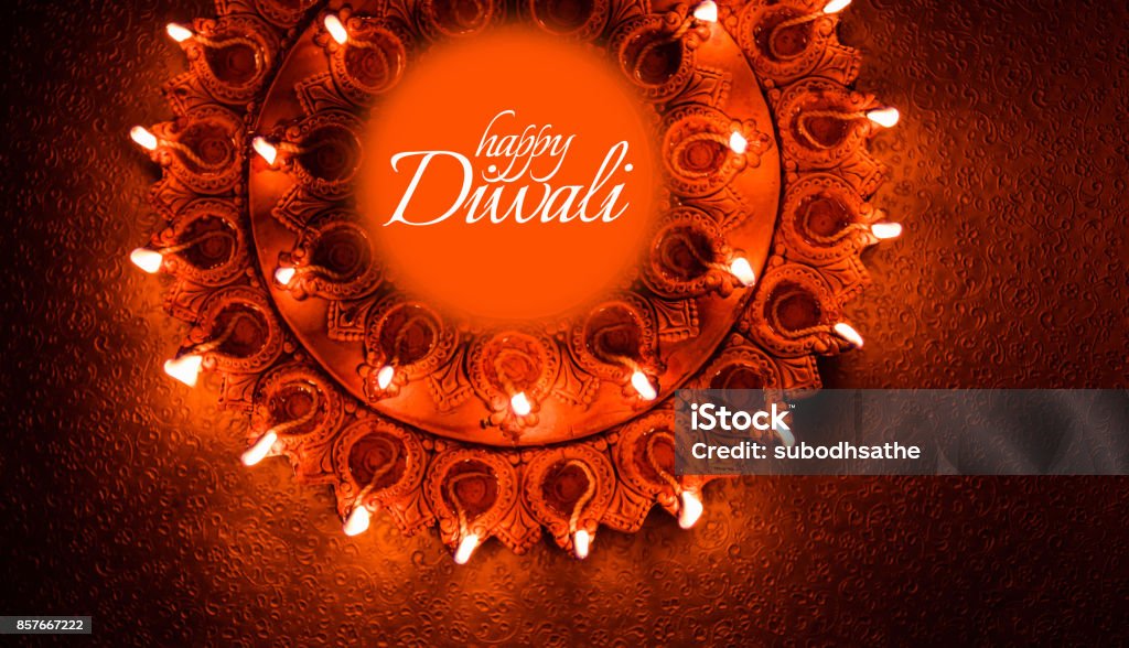 Happy Diwali greeting card design using Beautiful Clay diya lamps lit on diwali night Celebration.  Indian Hindu Light Festival called Diwali, a festival of light Diwali Stock Photo